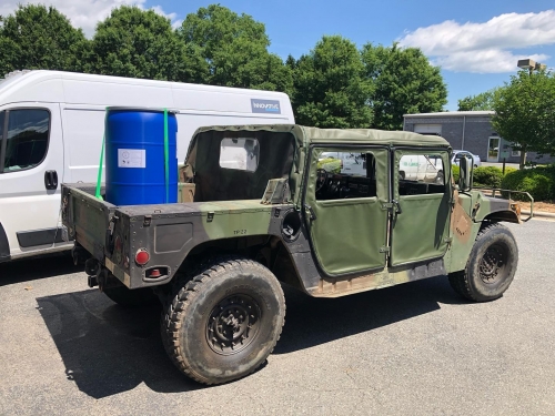 Barrel of Hand Sanitizer in back of army jeep